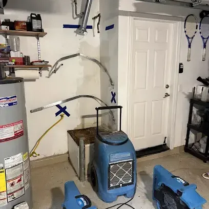 Drying equipment placed around a water heater in a garage