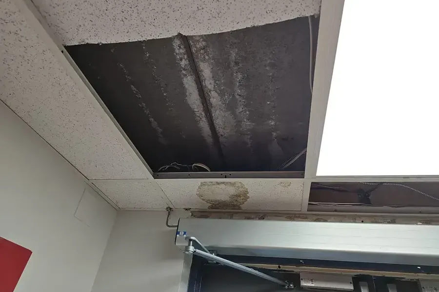 Missing drop ceiling tiles above a commercial space after a leak